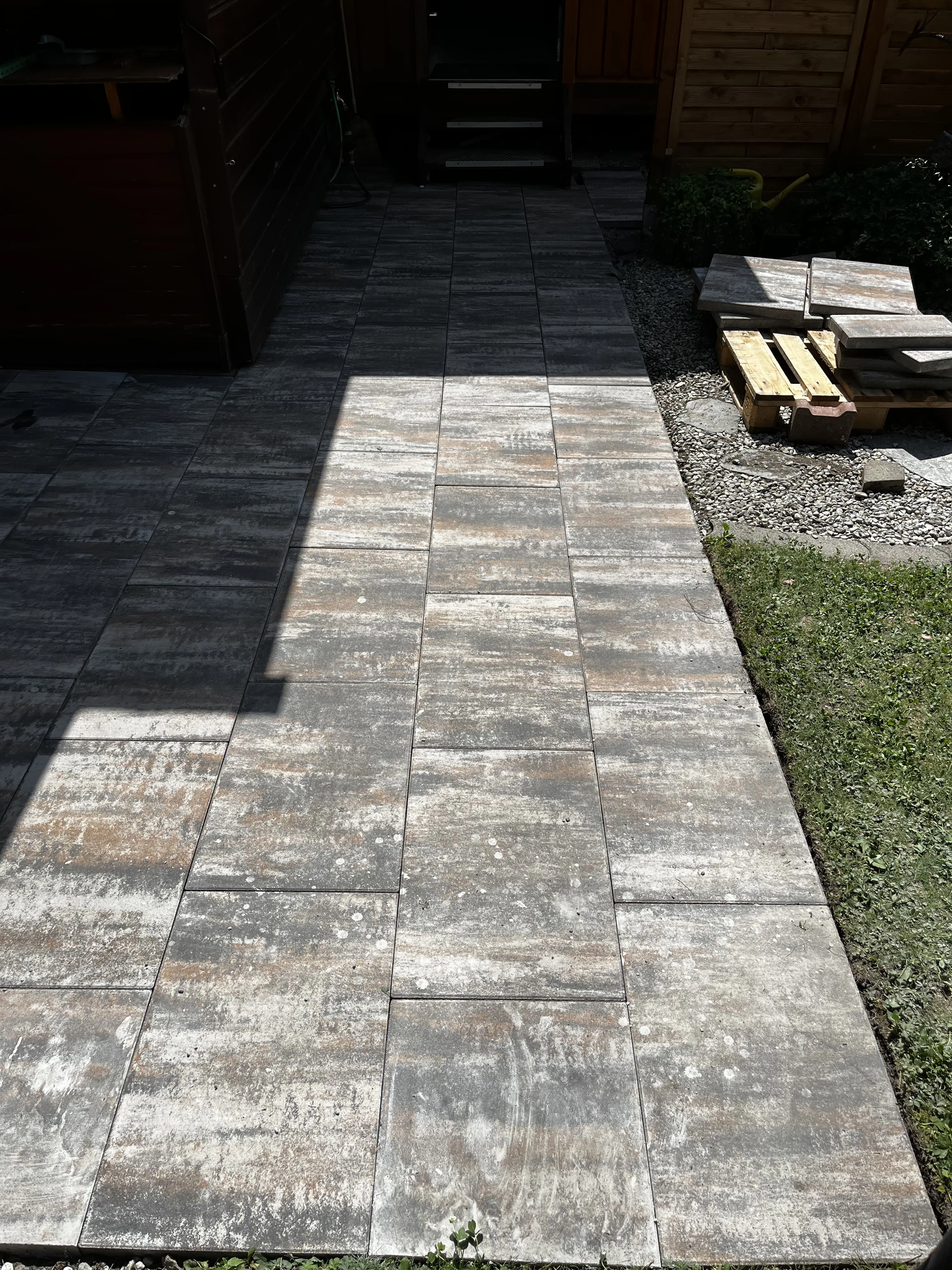 Verlegte Bodenplatten auf einem Terrassenweg mit Schatten